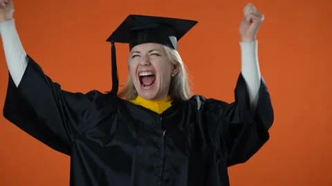 Slow motion portrait of excited dancing woman graduate thumbs up showing success Stock Footage 172153926