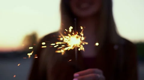 SLOW MOTION: Portrait of a girl model looks with sparklers in their hands Stock Footage 64448341