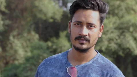 Slow motion portrait of a handsome young indian man looking at the camera Stock Footage 150686885