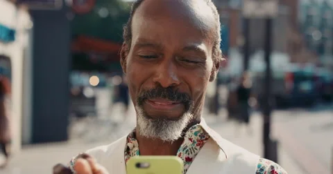 Slow Motion Portrait of happy mature african american man using smart phone Stock Footage
