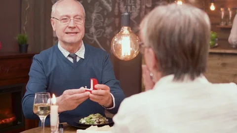 Slow motion portrait of a old man making a proposal to his partner Stock Footage 106453834
