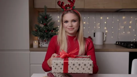 Slow motion portrait of young blonde woman presenting beautiful xmas gift box Stock Footage 166466205