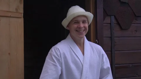 Slow motion, portrait of a young guy laughing on the threshold of a sauna. a Stock Footage 279169619