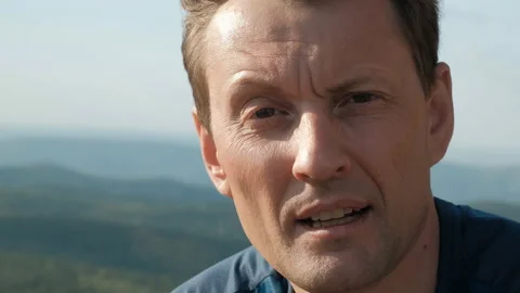 Slow motion portrait of a young man on top of a mountain. Stock-Footage 113407048