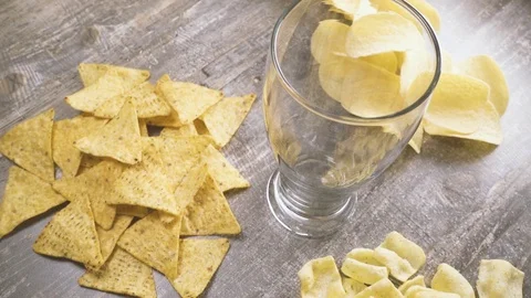 Slow motion pour beer and chips on the table top view Stock Footage 94121286