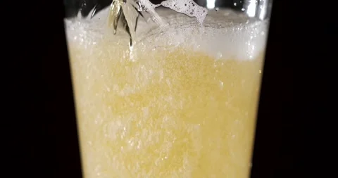 Slow motion pour of beer with bubbles and foam in a glass Stock Footage 340482584