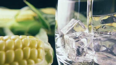 Slow motion pour bourbon into a glass of ice Stock Footage 91978393