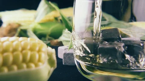 Slow motion pour bourbon into a glass of ice Stock Footage 91978589