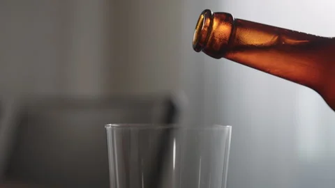 Slow motion pour ginger ale in a tumbler glass on table with copy space Stock Footage 253656115