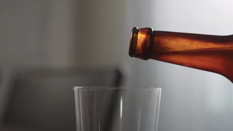 Slow motion pour ginger ale in a tumbler glass on table with copy space Stock Footage 253656495