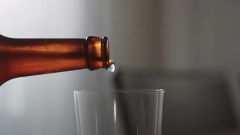 Slow motion pour ginger ale in a tumbler glass on table with copy space Stock Footage 253657526