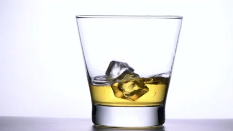Slow motion on pour ice cube into whisky isolated on white background, Stock-Footage 161109714