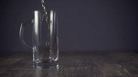 Slow motion pour light beer in a mug on a grey background Stock Footage 94625037