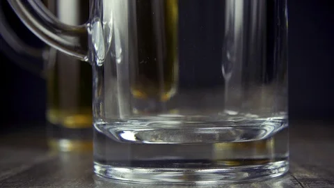 Slow motion pour light beer in a mug on a grey background close-up Stock Footage 94626530