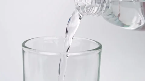 Slow motion of pour pure drinking water into a glass with white background. Stock Footage 169172361