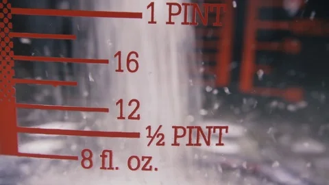 Slow motion pour the sugar into a measuring cup close-up Video stock 96030163