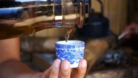 Slow motion of pour tea into cup of tea ancient Stock Footage 76001140