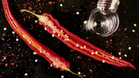Slow motion pour vodka with pepper on a black background Stock-Footage 92743998