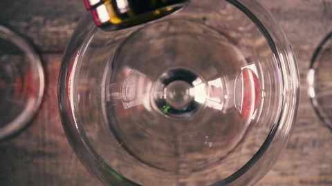 Slow motion pour white wine into a glass with reflection top view Stock Footage 93992645