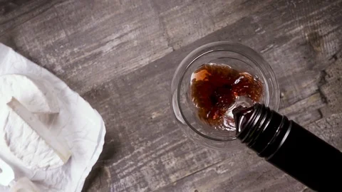 Slow motion pour the wine from the bottle into the glass and appetizer top view Stock-Footage 93698727