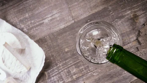Slow motion pour the wine from the bottle into the glass and appetizer top view Video stock 93698847