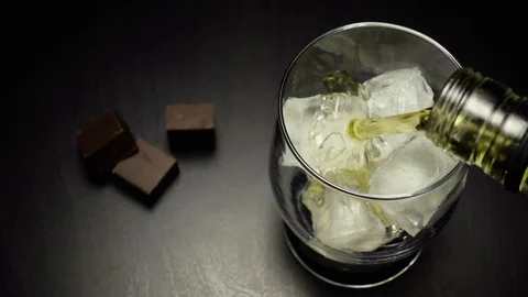 Slow motion poured from a bottle of whiskey Stock-Footage 72894632