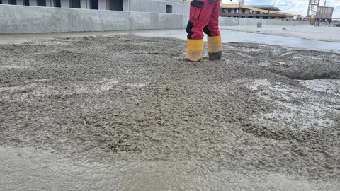 Slow Motion Pouring and Spreading Concrete on Roof Slab Stock Footage 340562837