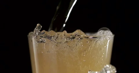 Slow motion pouring of beer with bubbles and foam rising in glass Stock Footage 340482511