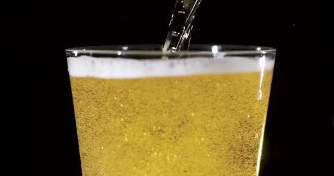 Slow motion pouring beer with bubbles and foam in a glass Stock Footage 340482545