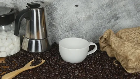 Slow motion of pouring coffee beans in a white coffee cup Stock Footage 73181105