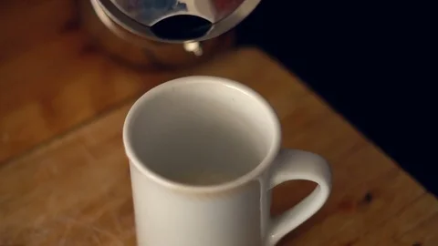 Slow motion pouring coffee into a cup Stock Footage 78545334