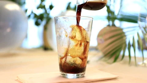 Slow motion of pouring cold coffee into glass with ice Stock Footage 91732383