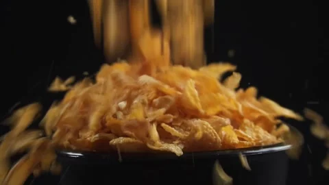 Slow motion of pouring corn flakes into empty bowl isolated black background Stock Footage 279700441