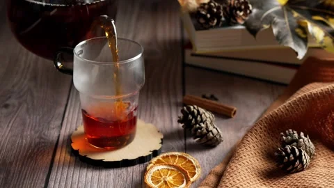 Slow motion pouring hot black tea in a glass Stock Footage 343764640