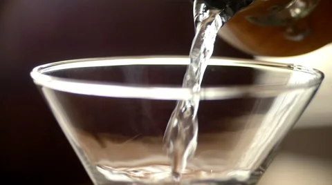 Slow motion pouring martini cocktail, dramatic lighting Stock Footage