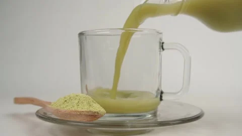 Slow motion of pouring matcha or green tea into a glass cup Stock Footage 278030725