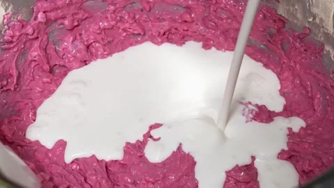 Slow Motion Pouring Milk into Vibrant Pink Raspberry or Strawberry Dessert Batte Stock Footage 337751203