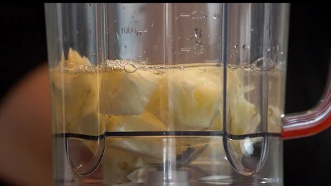 Slow Motion pouring pineapple cubes into the blender Stock-Footage 128003386