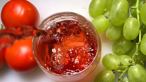 Slow motion of pouring red wine into glass with fresh grape and tomato setup Stock-Footage 93017199