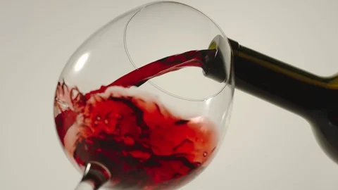 SLOW MOTION: Pouring red wine from a bottle into a glass - Bottom View Stock Footage 101816833