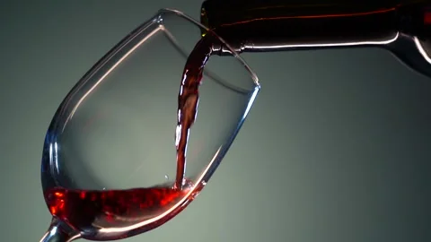 Slow motion of pouring red wine from bottle into goblet. Close-up of red wine Stock Footage 162227104