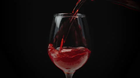Slow motion of pouring red wine from bottle into goblet. 100fps 4K resolution. Stock Footage 171546128