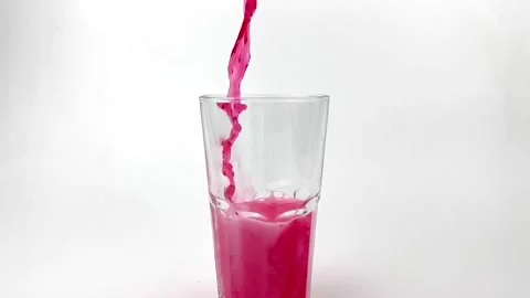 Slow motion pouring soft Drinks, red soda with ice into Glass Isolated Stock Footage 171153220