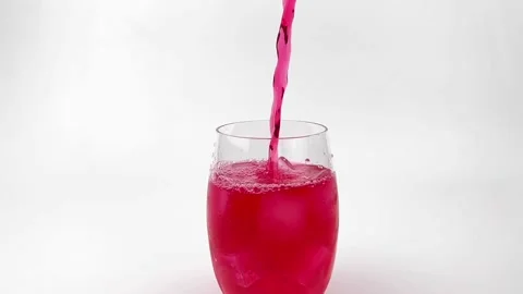Slow motion pouring soft Drinks, red soda with ice into Glass Isolated Stock Footage 171153224