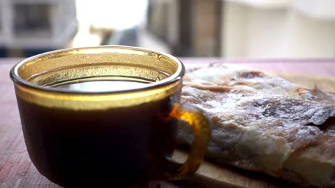 Slow motion pouring tea into a cup and a piece of cake. Stock Footage 112364743