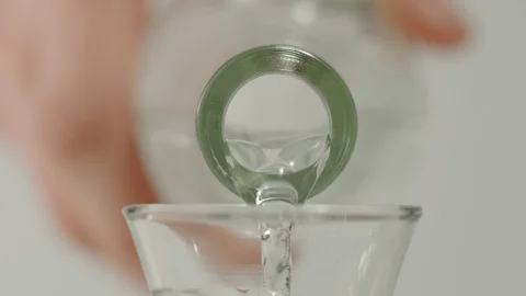 SLOW MOTION: Pouring vodka from a bottle into a glass - Macro Stock Footage 101816963