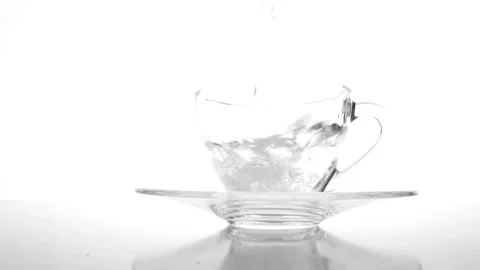 Slow-motion: Pouring water into a drinking glass on white background. splas.. Stock Footage 265845058