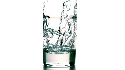 Slow-motion, Pouring water into a drinking glass. Close up slow motion pourin Stock Footage 265847902