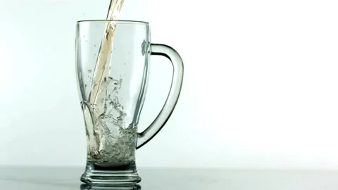 Slow motion of pouring water from a spring water into a glass on wooden table Stock Footage 265842208