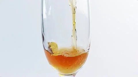 Slow motion of pouring white wine into a glass close-up on a white background Stock Footage 168472423